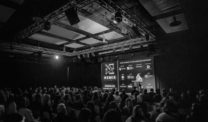 Man addressing a crown on stage at Remix London 2025