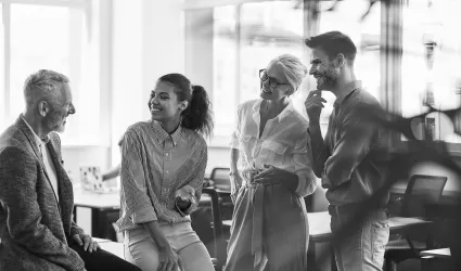 Employees talking together in an office. 