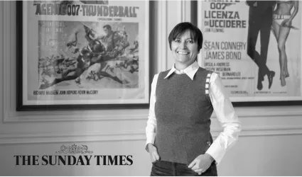 Catherine Turner posing in front on posters, with the Sunday Times logo
