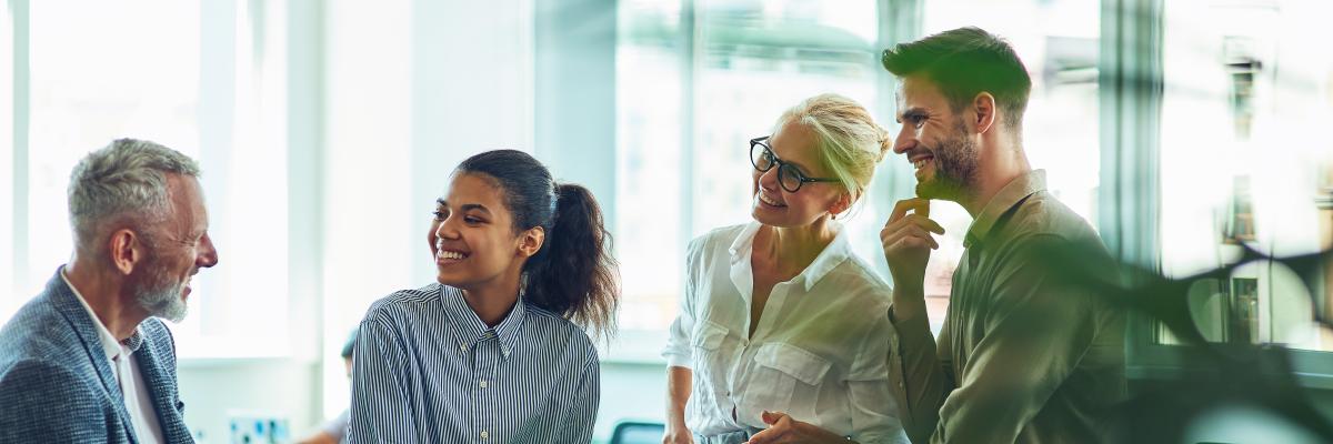 Employees talking together in an office.