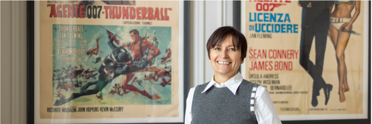 Catherine Turner posing in front on posters, with the Sunday Times logo